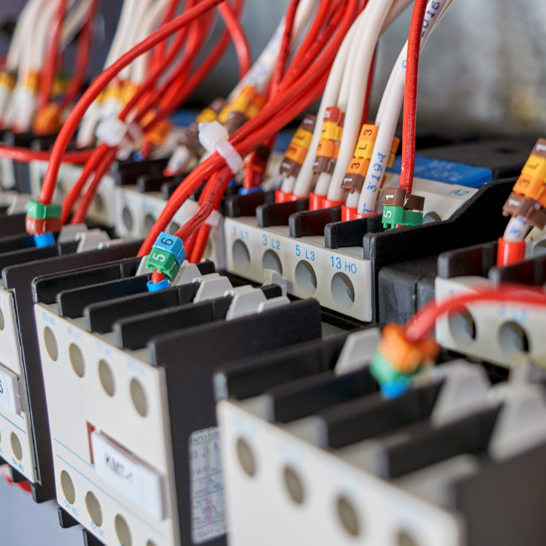 Many electrical wires or cables are connected to contactors and additional contacts in the electrical Cabinet.